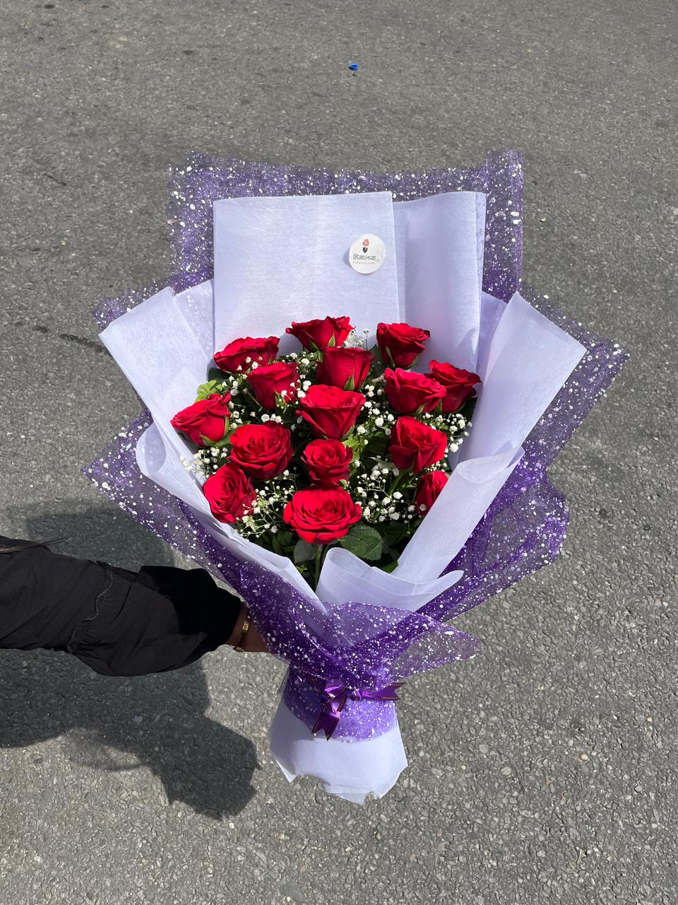 Delight them with 15 premium red roses elegantly encased in luxury net wrapping. A modern, high-fashion take on classic romance. Order fresh today!