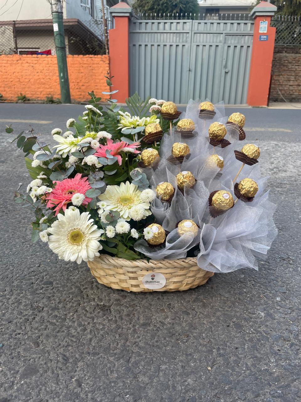 Brighten their day with our premium handcrafted basket featuring vibrant gerbera daisies and gold-wrapped Ferrero Rocher chocolates. Order fresh today!