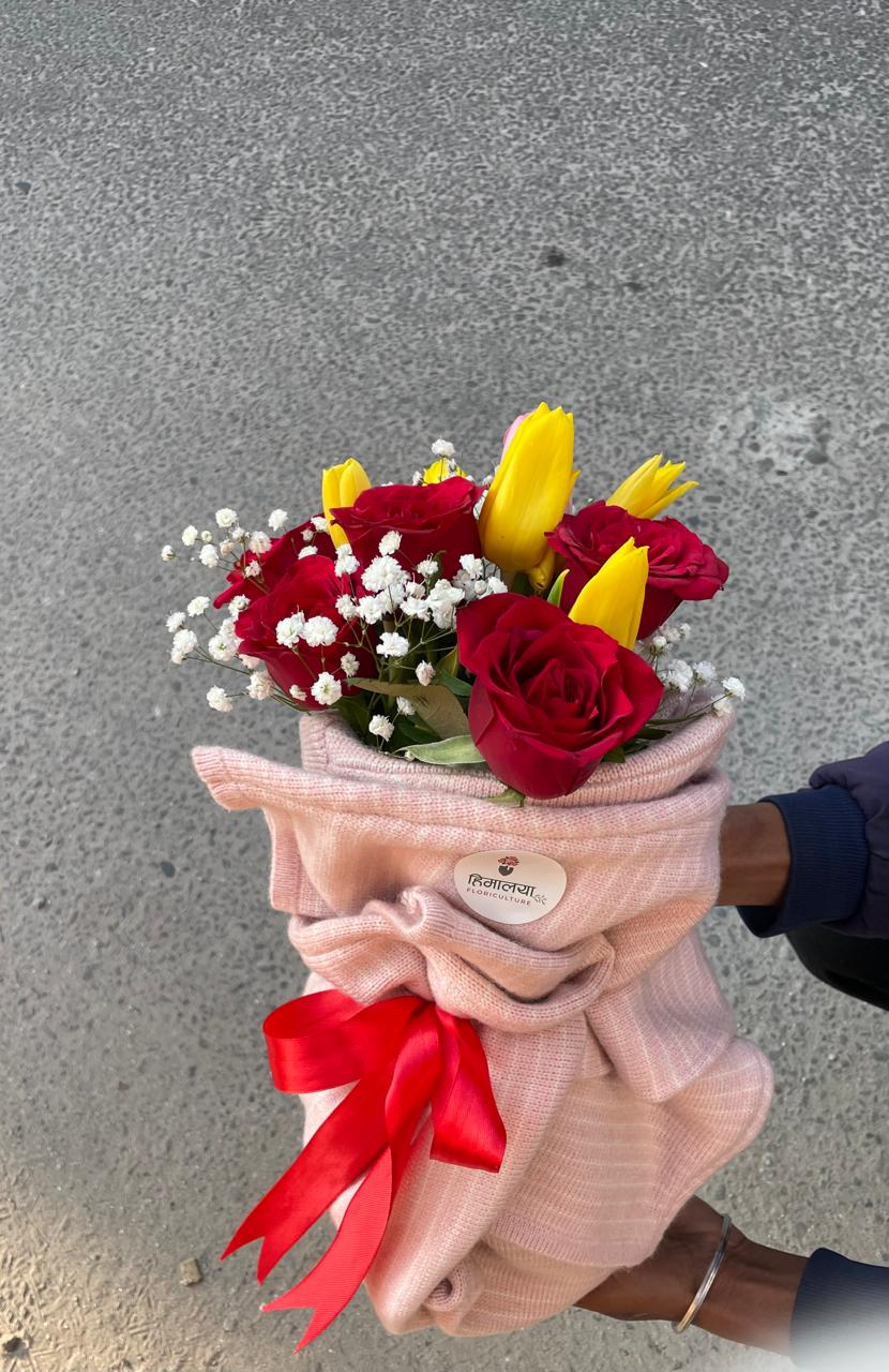 Delight them with our luxury red rose and tulip bouquet beautifully wrapped in a premium cozy knit sweater. A unique, tactile romantic gift. Order fresh today!