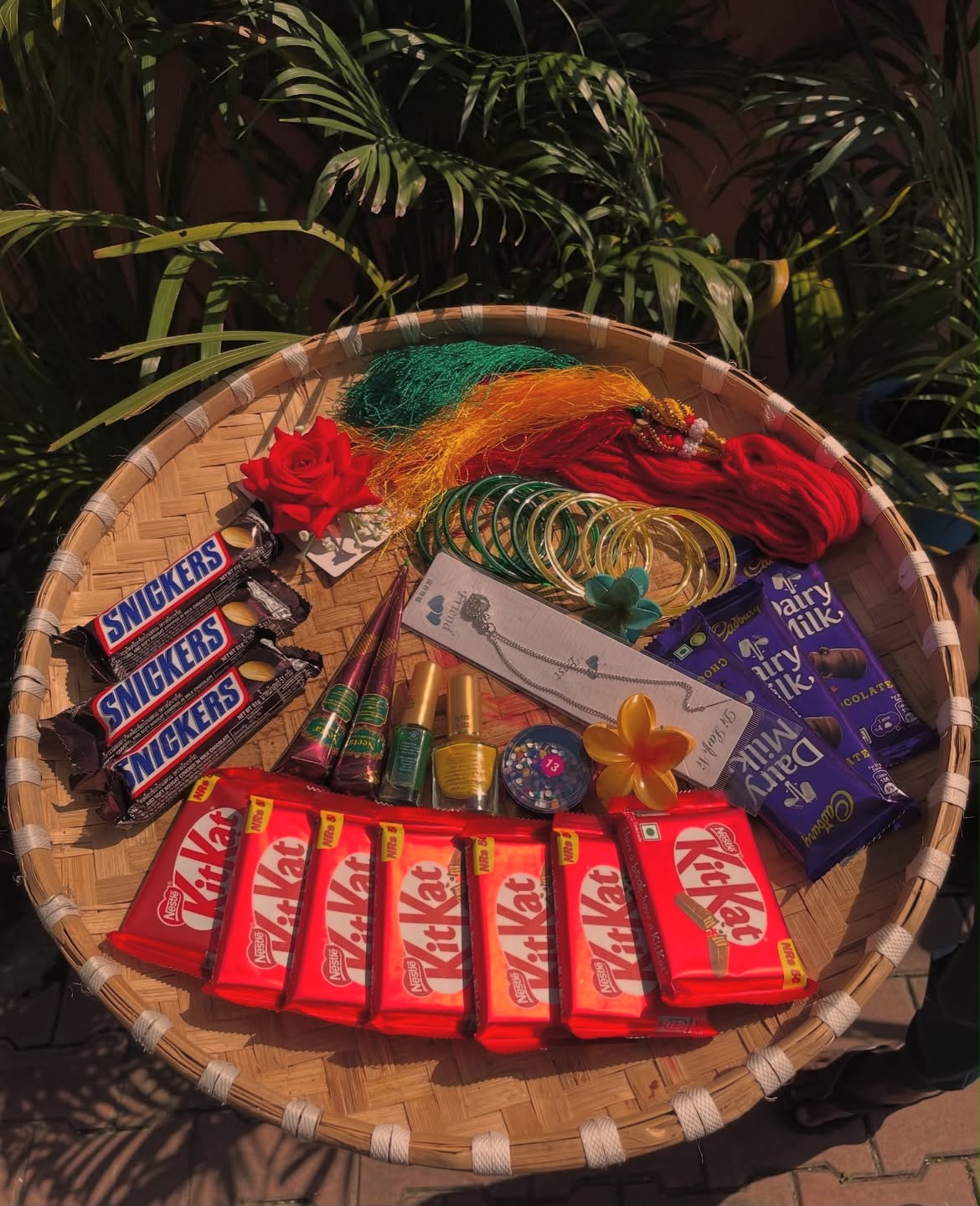 This Shrawan Combo is carefully assembled with festive accessories, beauty essentials, and chocolates to create a thoughtful gift for the season. Product colors, accessory designs, jewelry styles, and chocolate packaging may vary slightly depending on availability while maintaining the overall festive theme and value of the combo. Please store chocolates in a cool, dry place away from direct sunlight. This combo is ideal for Shrawan, Teej, festive celebrations, and gifting to family and friends.