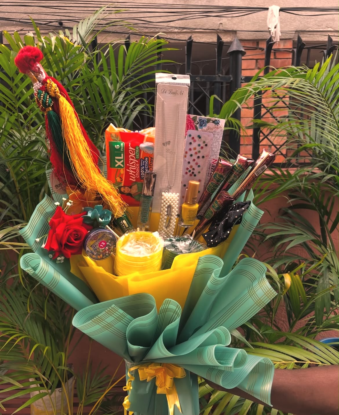 Each Shrawan Gift Bouquet is carefully handcrafted and beautifully wrapped using premium bouquet paper. Product colors, accessory designs, jewelry styles, and wrapping may vary slightly depending on availability while maintaining the overall festive theme and quality. This bouquet is perfect for Shrawan, Teej, festive celebrations, and thoughtful gifting to family, friends, or loved ones.