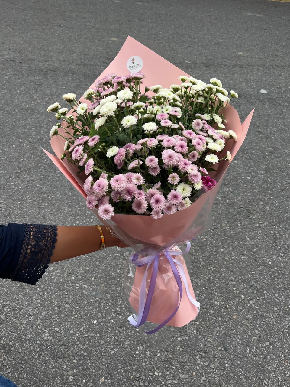 As flowers are natural products, the size, bloom stage, and shades of white and pink may vary slightly depending on seasonal availability. The wrapping style may also differ while maintaining the bouquet's premium presentation and overall elegance. To enjoy maximum freshness, place the flowers in clean water and keep them away from direct sunlight and excessive heat.