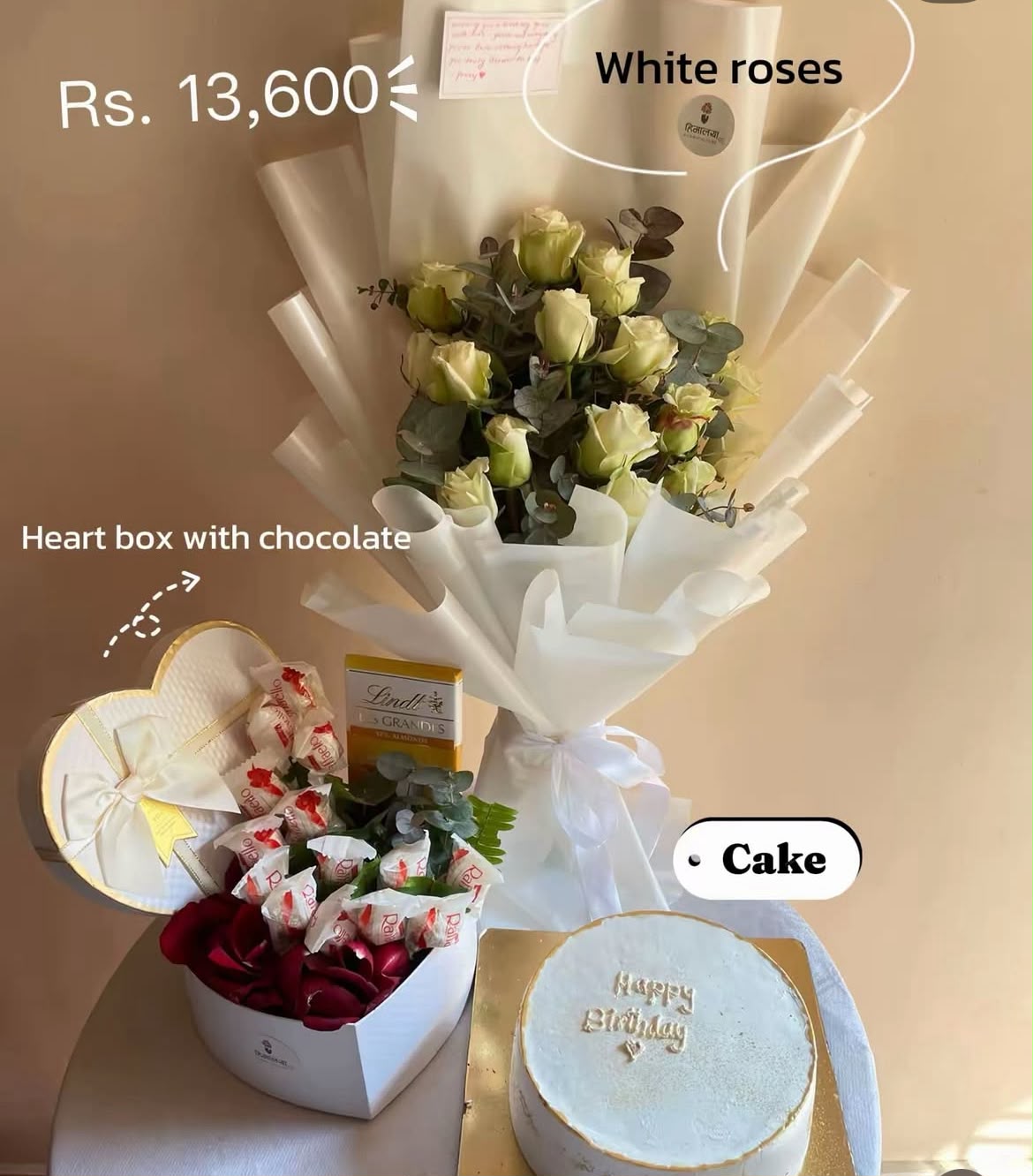 As flowers are natural products, the size, bloom stage, and shades of white roses may vary slightly depending on seasonal availability. Silver dollar foliage may be replaced with other suitable green fillers based on availability while maintaining the bouquet's overall design and elegance. Cake flavor, chocolate box selection, and packaging may vary slightly while preserving the quality and value of the combo. Please store the cake and chocolates properly after delivery to maintain freshness.