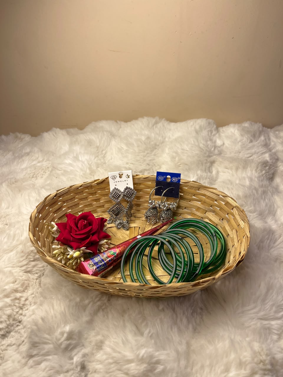 This combo includes a decorative basket as shown. Product colors, designs, and styles of the basket and accessories may vary slightly depending on availability while maintaining the overall quality and value of the combo. This festive basket is perfect for celebrating Shrawan, Teej, and other special occasions or for gifting your loved ones.