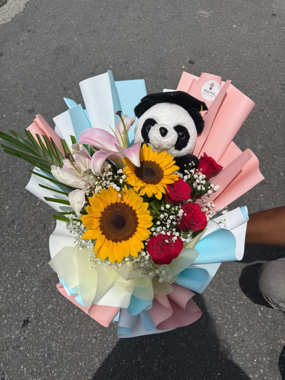 As flowers are natural products, the size, bloom stage, and flower shades may vary slightly depending on seasonal availability. The panda doll design and wrapping style may also differ while maintaining the bouquet's premium presentation and overall appeal. To enjoy maximum flower freshness, place the stems in clean water and keep them away from direct sunlight and excessive heat.