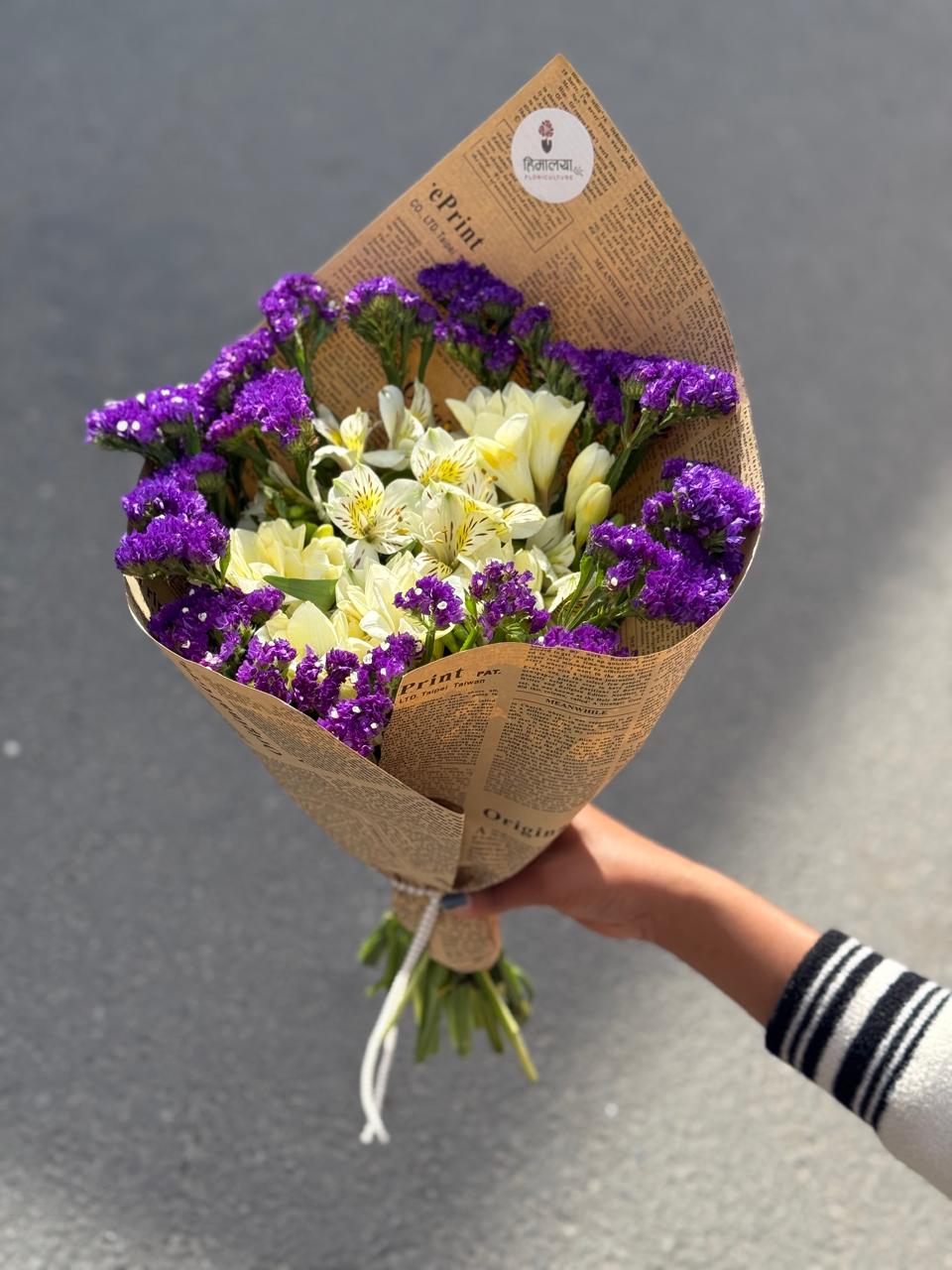 As flowers are natural products, the size, bloom stage, and shades of flowers may vary slightly depending on seasonal availability. The amount and style of filler flowers may vary while maintaining the bouquet's overall design and appearance. The newspaper wrapping style may also differ slightly depending on availability while ensuring a unique and elegant presentation. To keep the flowers fresh for longer, place them in clean water and keep the bouquet away from direct sunlight and excessive heat.