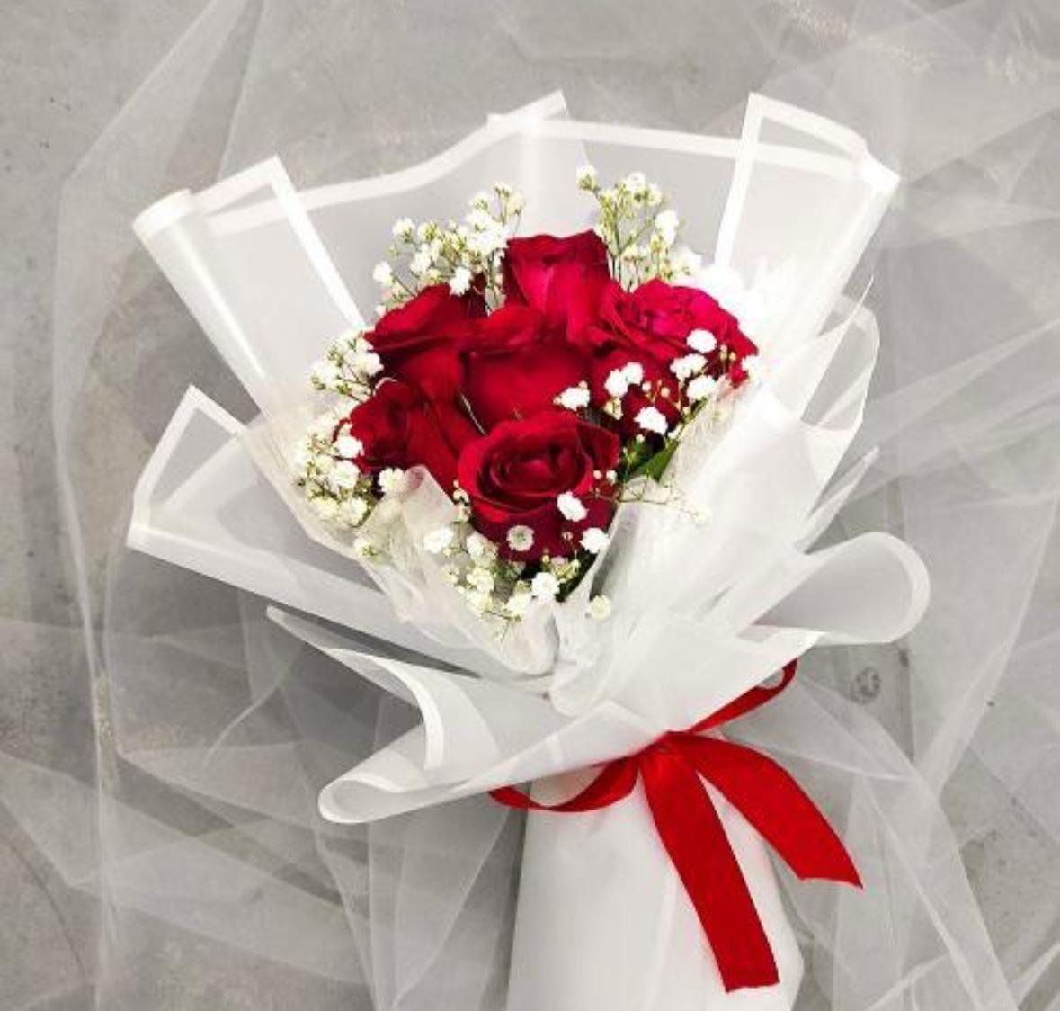 As flowers are natural products, the size, bloom stage, and shades of red may vary slightly depending on seasonal availability. The wrapping style may also differ while maintaining the bouquet's premium presentation and overall elegance. To keep your roses fresh for longer, place them in clean water, trim the stems at an angle, and keep the bouquet away from direct sunlight and excessive heat.