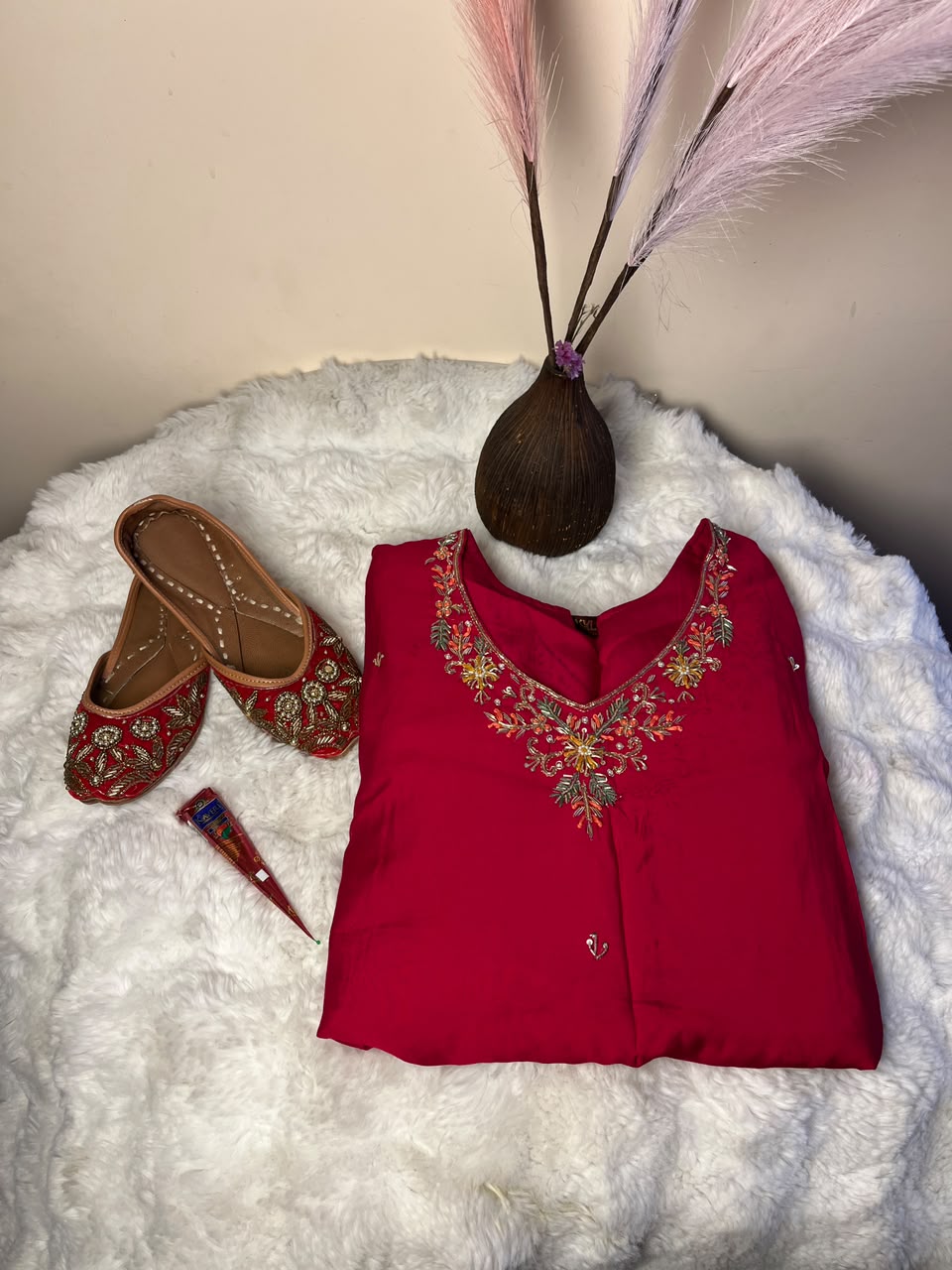 The design, shade, size, and style of the red kurtha set, juttis, and mehendi brand may vary depending on stock availability. Suitable replacements of equal or greater value will be provided while maintaining the overall quality, festive appeal, and presentation of the gift combo.