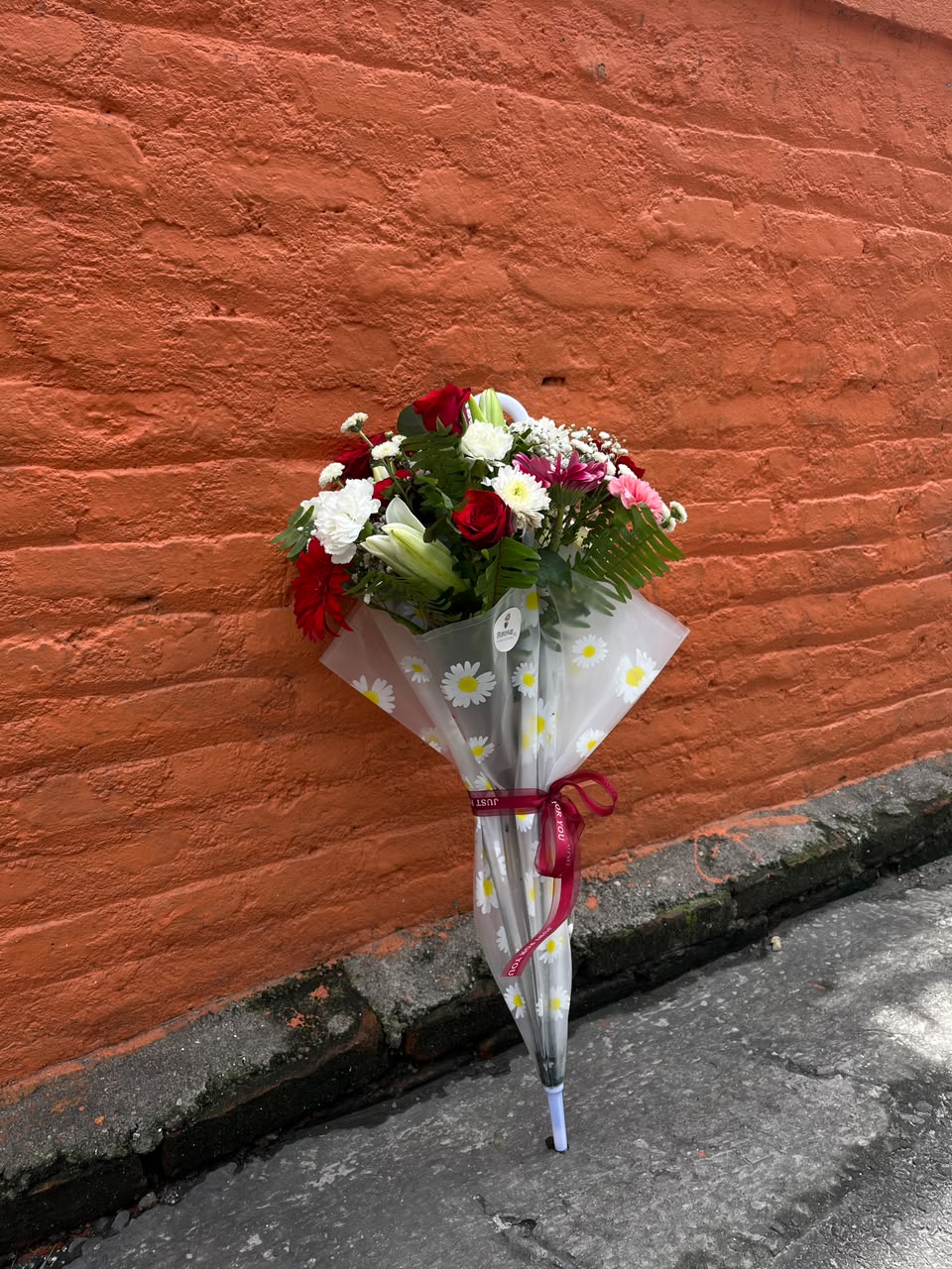 Flower varieties, colors, fillers, and umbrella style may vary depending on seasonal availability. Suitable flower substitutions will be made while maintaining the overall design, freshness, and premium quality of the arrangement.