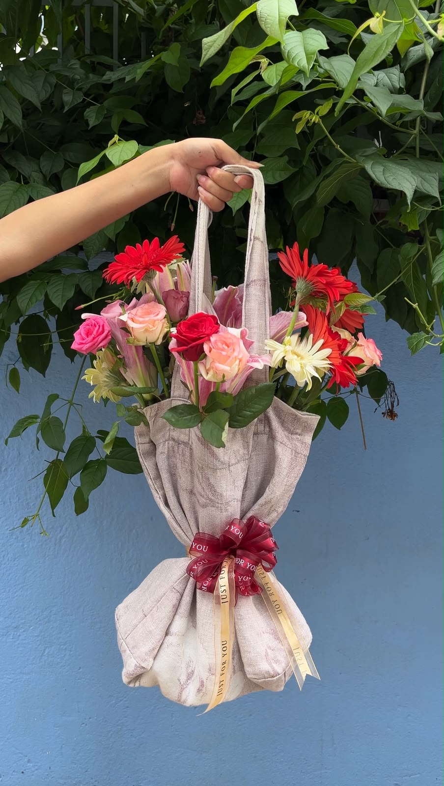Flower varieties, colors, fillers, and tote bag design may vary depending on seasonal availability. Suitable flower substitutions will be made while maintaining the overall design, freshness, and premium quality of the arrangement.